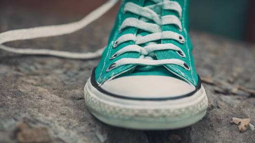 A close-up of a pair of cool teal colored Converse sneakers.