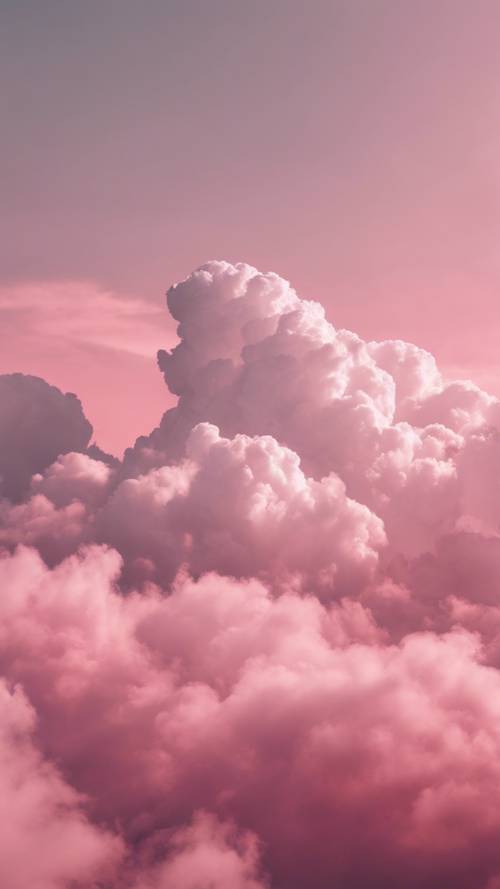 A fluffy cloud grazing by, tinted with shades of pink from deep to a delicate ombre of soft pastel, creating a stunning pink sky.