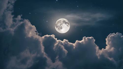 A deep blue night sky with ethereal wisps of white clouds reflecting the moon's light.