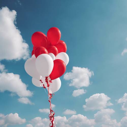 Festive red and white balloons strung together against the blue sky.