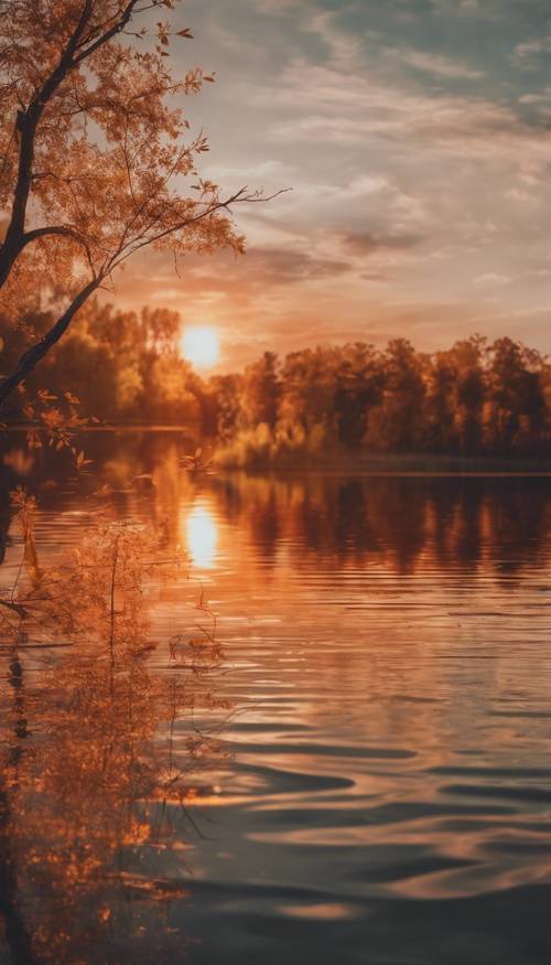 A vibrant sunset with a mix of orange and brown hues reflecting off a calm lake. Tapet [60e7f196015b4690a98a]