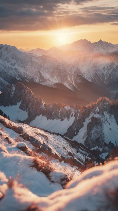 雪を被ったアルプス山脈の背後に沈む夕日の壮大な景色壁紙