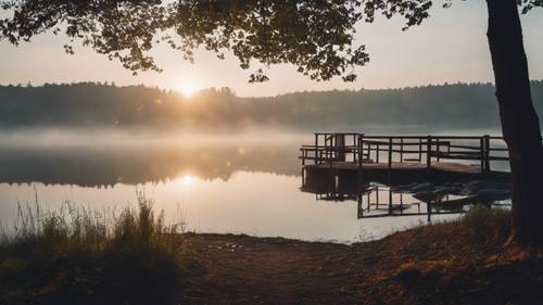 A scenic view of a misty lake at dawn encapsulates 'The only limit to our realization of tomorrow will be our doubts of today'.