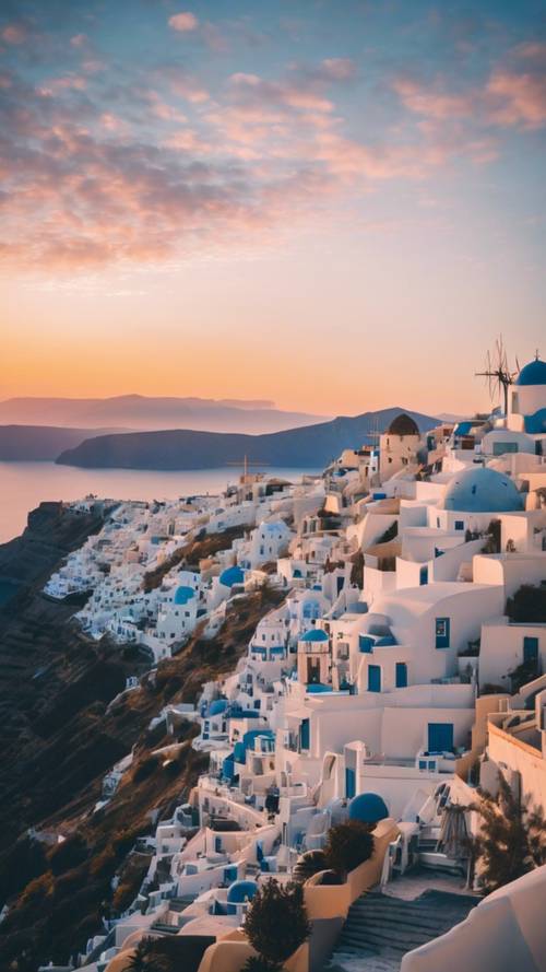 A dreamy skyline view of Santorini with its iconic blue-domed churches against the setting sun.