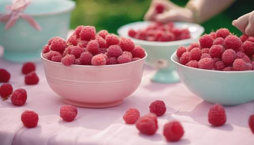 A group of raspberries in pastel colored preppy clothes and pearls, having a garden party on a sunny afternoon.