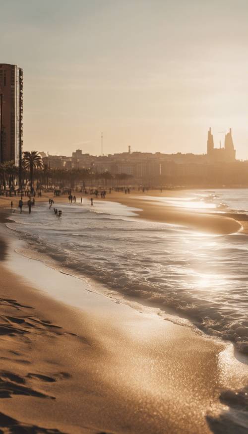 An early morning view of Barcelona's beach, the sun barely peeking over the calm Mediterranean Sea.