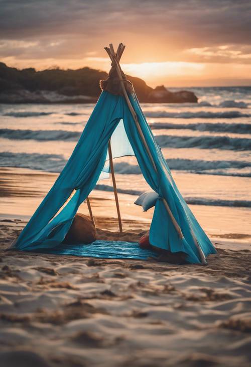 Pemandangan pantai saat matahari terbenam dengan tenda pantai bergaya boho berwarna biru.