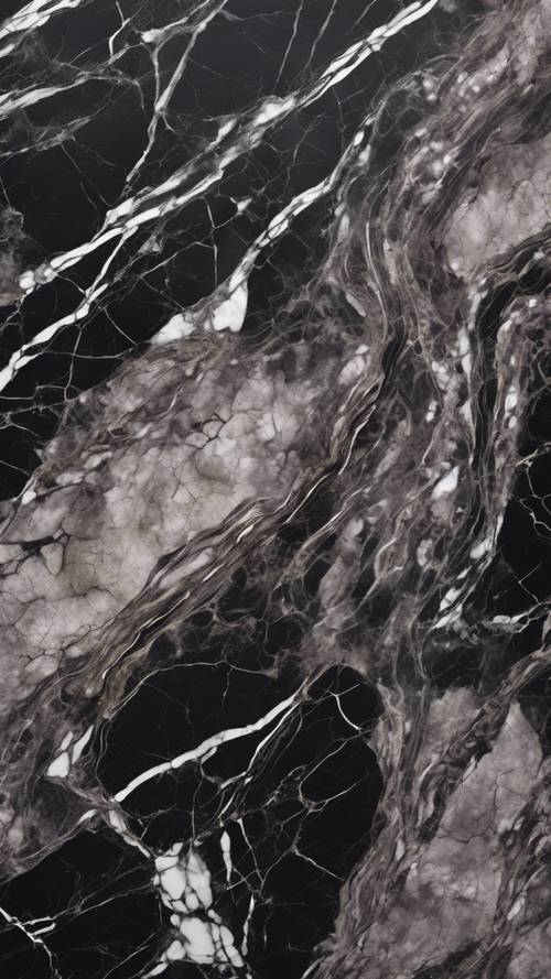 A closeup of polished dark marble with striking white veins. Tapet [9988a5e46e7948f697fd]