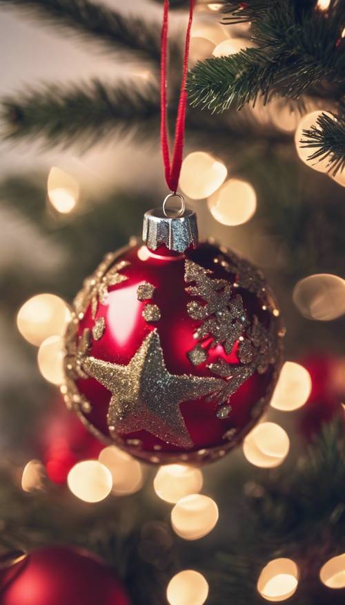 A decorated, cute red Christmas ornament hung on a festive tree.