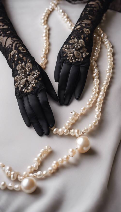 A pair of long, black lace gloves resting beside a pearl necklace Tapet [48d34eccf1a94db3b51e]