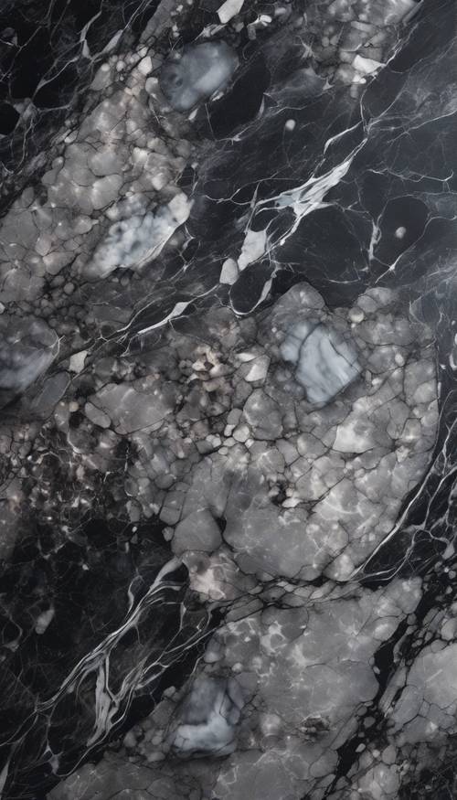 Yumuşak ışık altında cilalı siyah ve gümüş mermer yüzeyin yakın çekim görüntüsü.