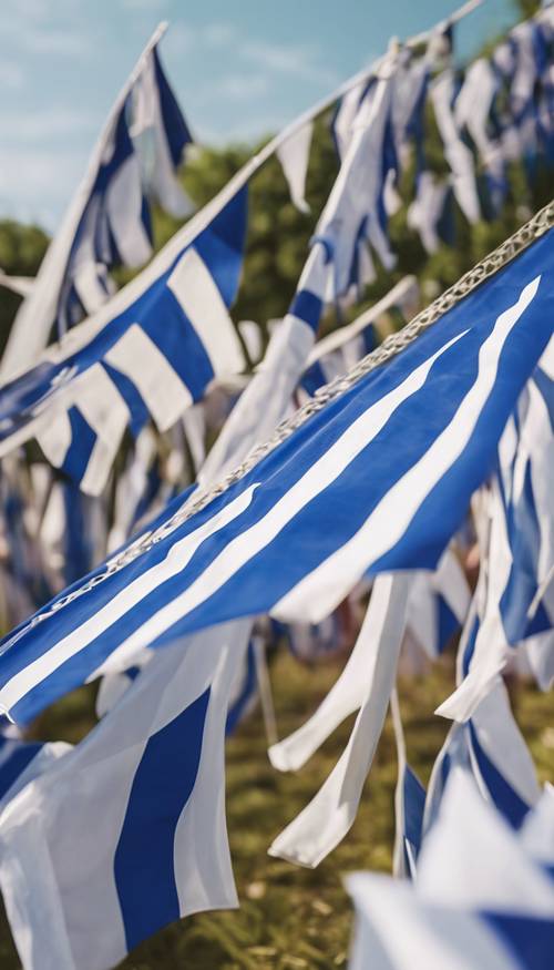 Blue and white pennant-style flags fluttering in the wind at a jovial summer festival.