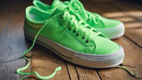 A pair of cool neon green sneakers on a wooden floor.