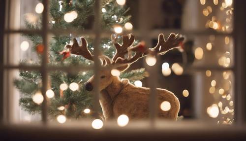 A reindeer peeping curiously into an illuminated window, where a family can be seen unwrapping gifts around a Christmas tree.