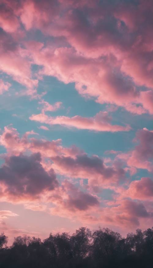 A vast sky at dusk, filled with an elegant dance of pink and blue pastel clouds