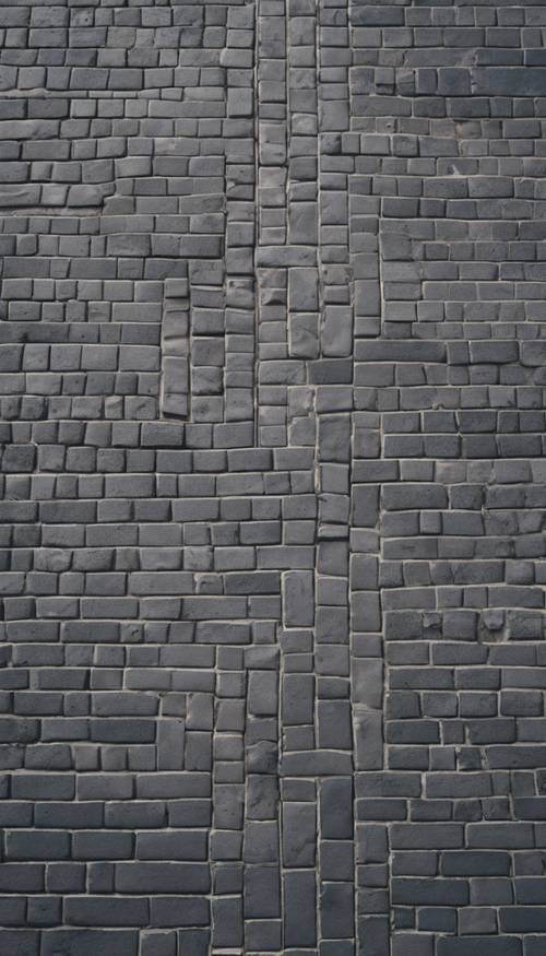 A bird's eye view of a city street paved in gray herringbone brick.