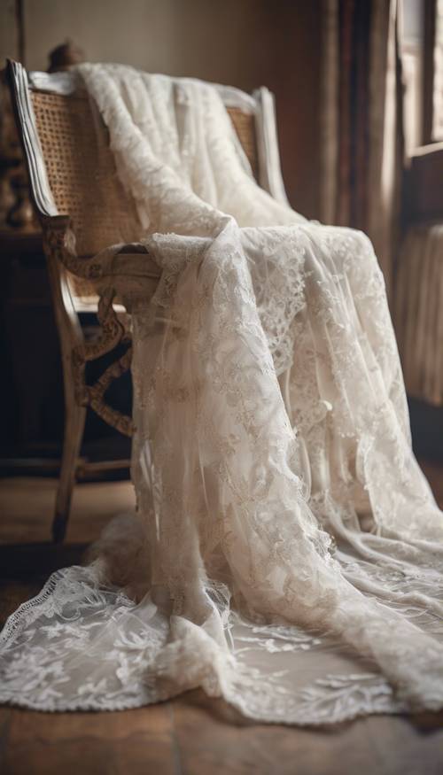 Vintage white lace wedding dress draped over an antique chair.
