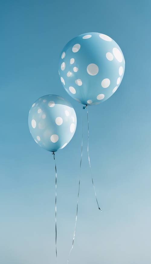 A large, round blue balloon with white polka dots floating against a clear blue sky.