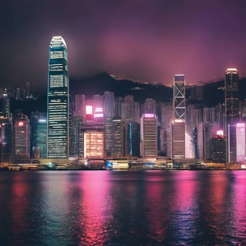 Night view of the dazzling Hong Kong skyline with neon lights reflecting off the water in Victoria Harbour.