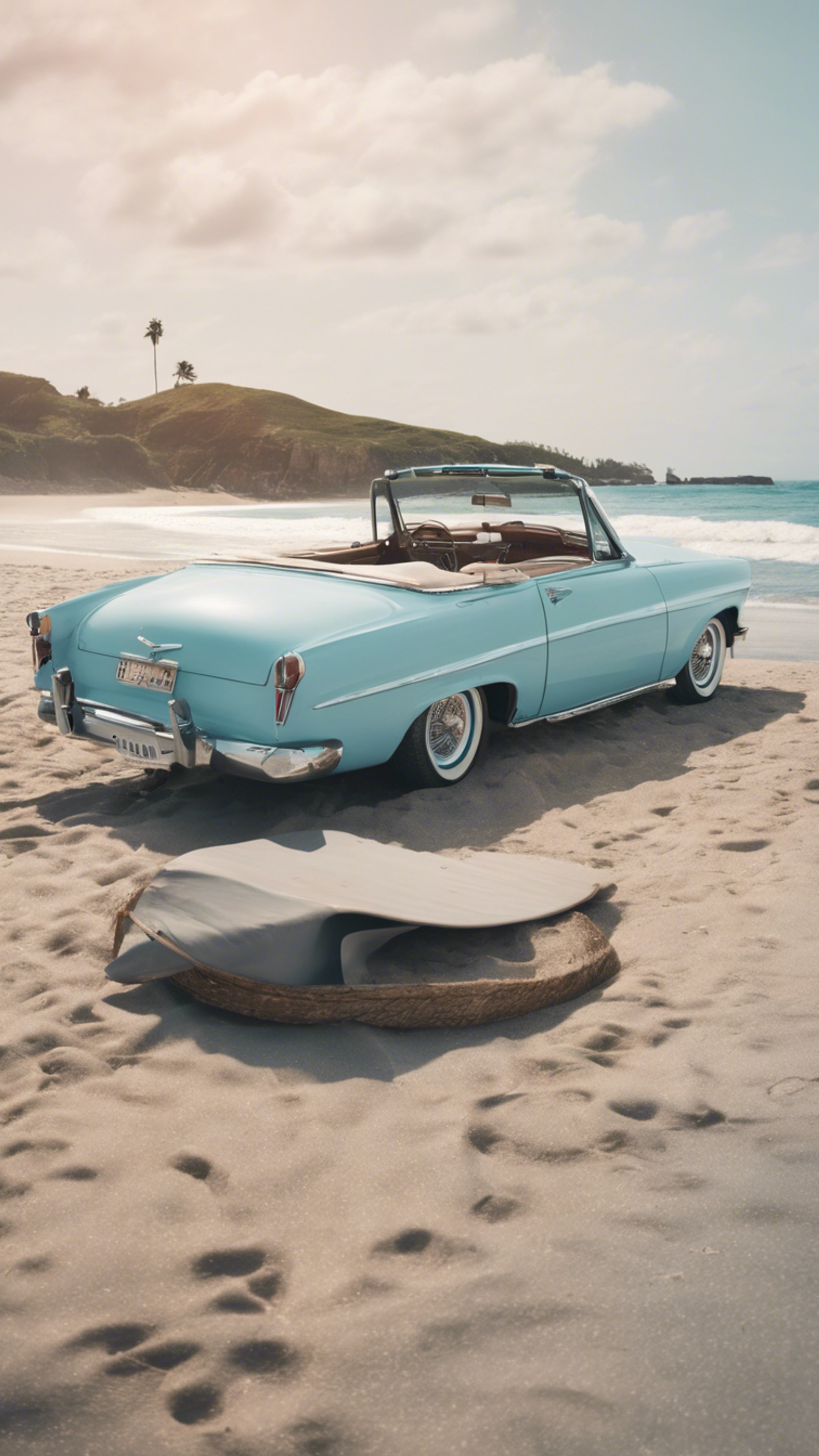 A vintage pastel blue convertible parked by a beach with surfboards leaning against it. Tapeta[b081d9fd70654569bba1]