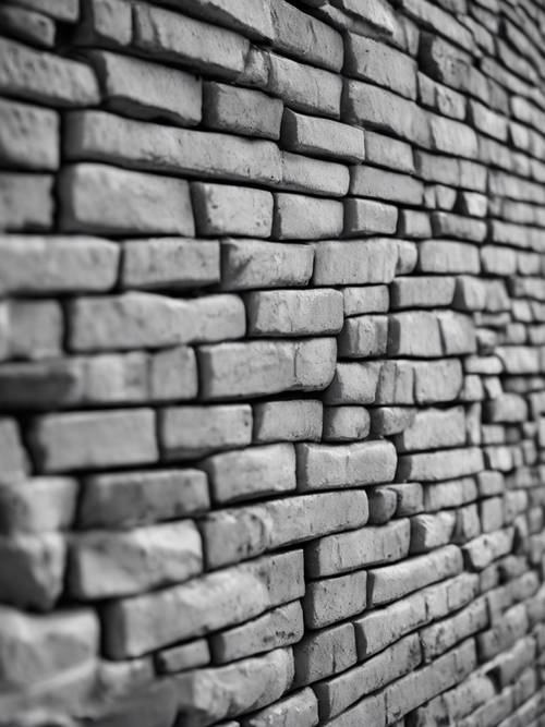 Close up of gray bricks forming a textured wall in a grayscale image.