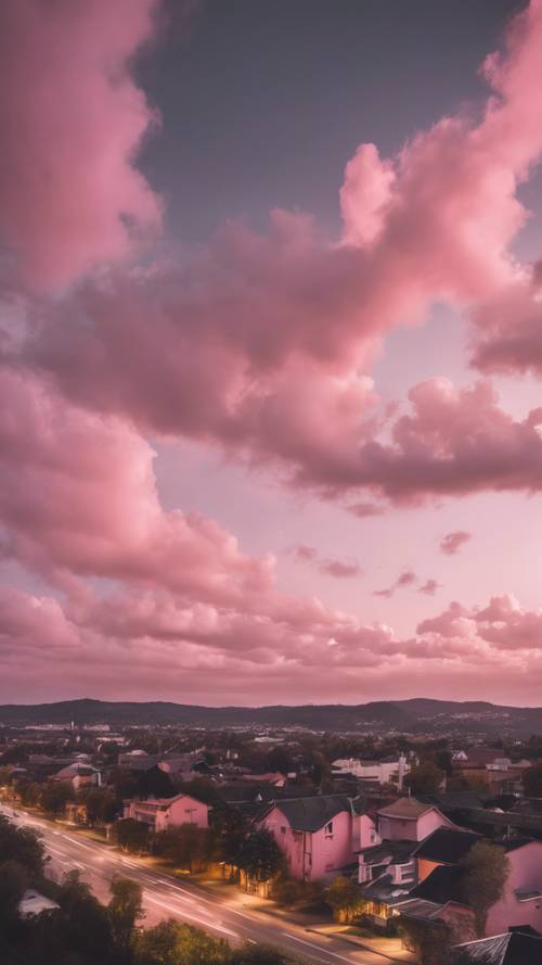 Long exposure photo of soft pink clouds streaking across a dreamy twilight sky