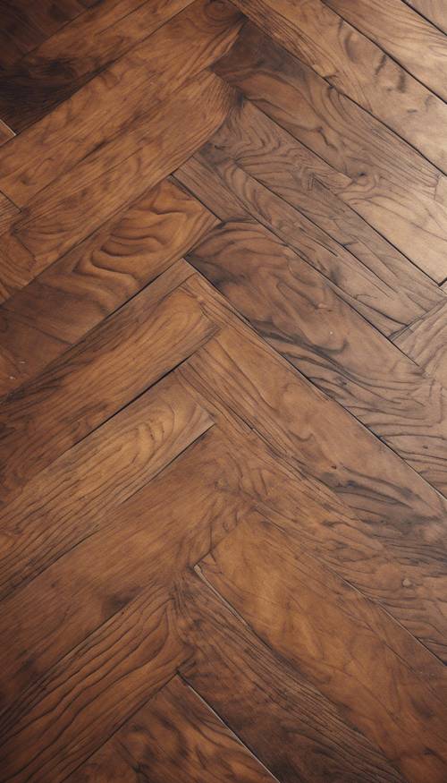 A herringbone pattern on a rich chestnut wooden floor of a Victorian house.