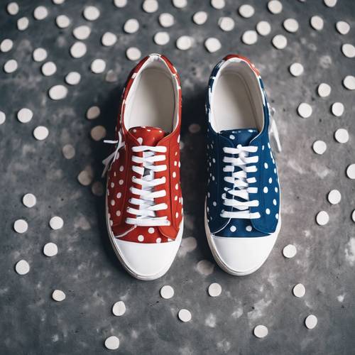 Designer sneakers with blue fabric and white polka dots, a shot taken from above on a concrete background.