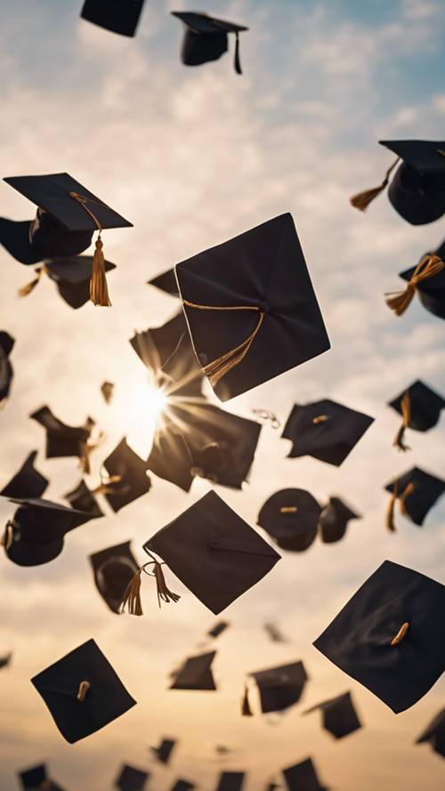 A graduation cap thrown in mid-air, with the bright sun setting in the background. Tapeta [dcc2d91d4100465a97c4]