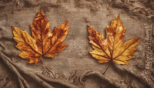 Un par de hojas de otoño estampadas sobre una bandana marrón.