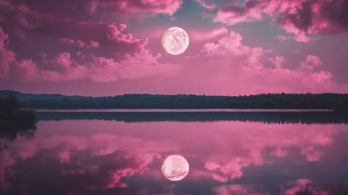 A breathtaking view of pink clouds mirroring on a body of water under a full moon. Tapet [3e5144d7ef664631818d]