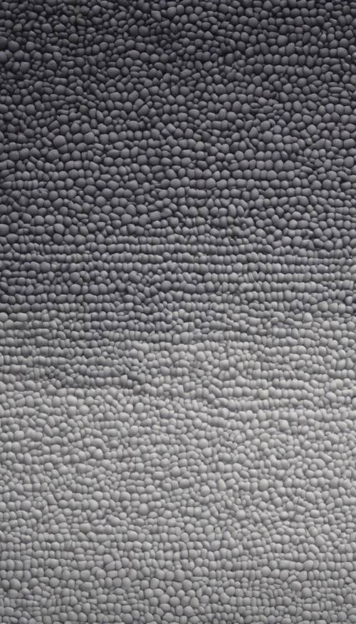 Ein moderner grauer Ombre-Teppich mit einem Farbverlaufseffekt von Dunkelgrau an den Rändern zu Hellgrau in der Mitte.