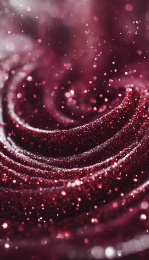 Abstract swirling pattern made up of specks of burgundy glitter.