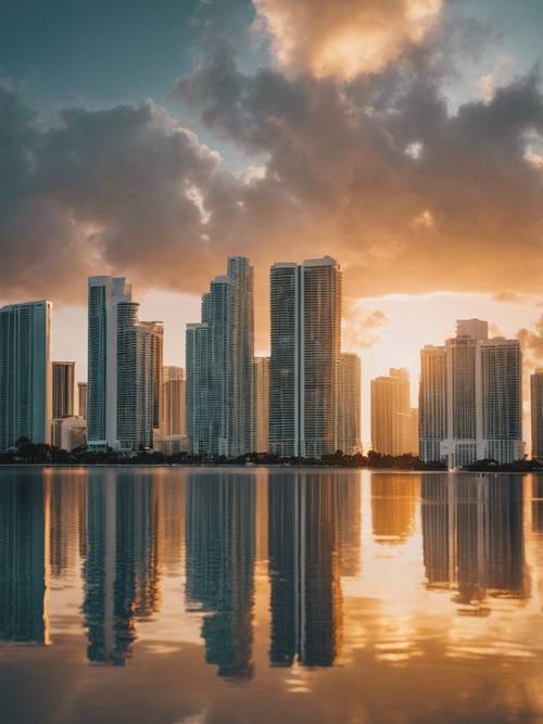 The Miami skyline in Florida, towering skyscrapers reflecting the setting sun over Biscayne Bay.