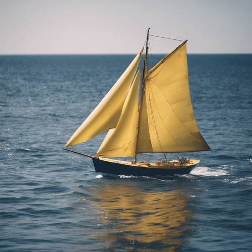 A yellow sailboat sailing on a navy blue sea during a sunny day