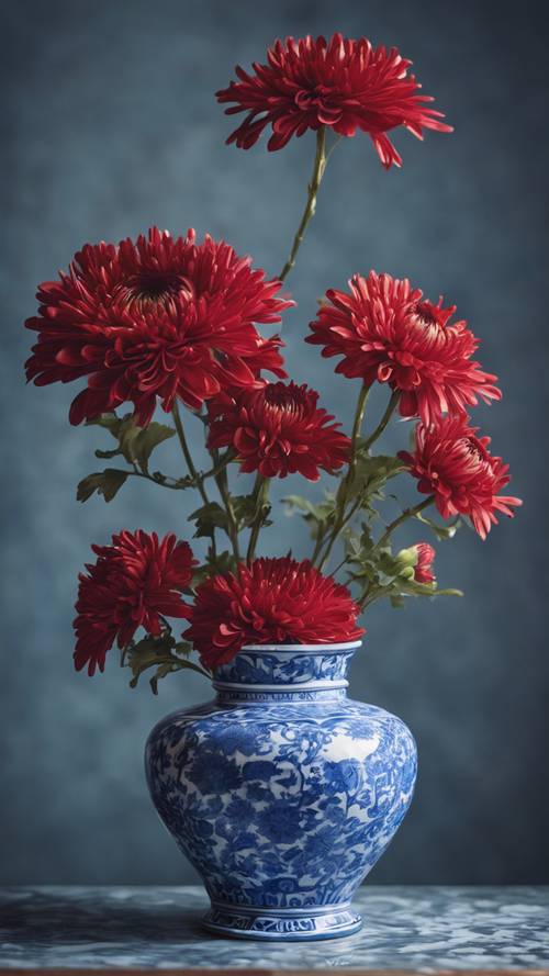 Red chrysanthemums in a classical blue porcelain vase.