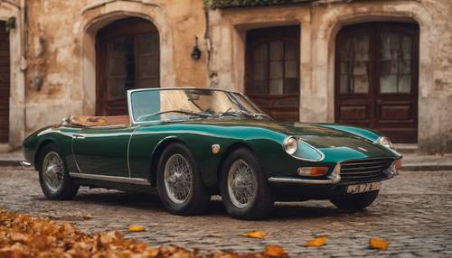 A vintage dark green Italian sports car parked by the side of an aged cobblestone road, bathed in autumn sunlight.