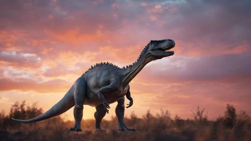 すばらしい色合いの夕焼けに捉えられた、灰色の恐竜