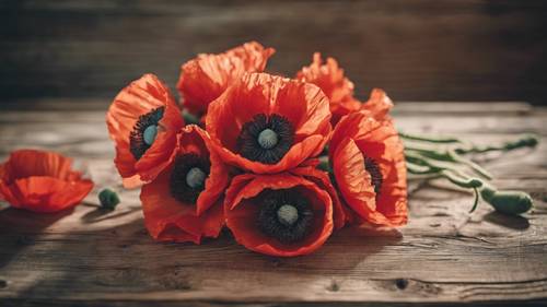 A handcrafted bouquet of poppy flowers resting on an old wooden table.