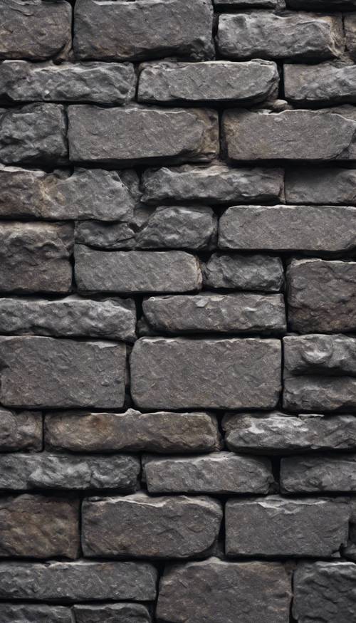 Close de um único tijolo cinza escuro mostrando sua textura áspera.