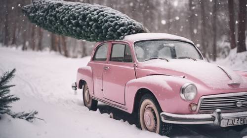 A retro pink car carrying a freshly cut Christmas tree on snowy roads.