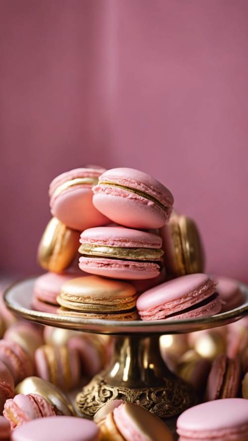 Elegant pink and gold french macaroons displayed on a dessert table.