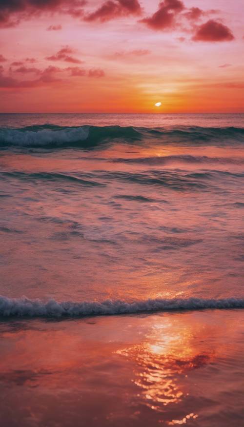 Piękny widok na zachód słońca nad spokojnym tropikalnym oceanem, z zachodzącym słońcem malującym niebo w żywych odcieniach pomarańczy, różu i czerwieni.