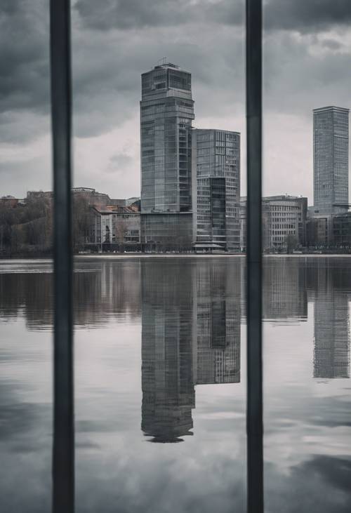 A still lake during a cloudy day, reflecting the modern gray architecture of the city nearby.