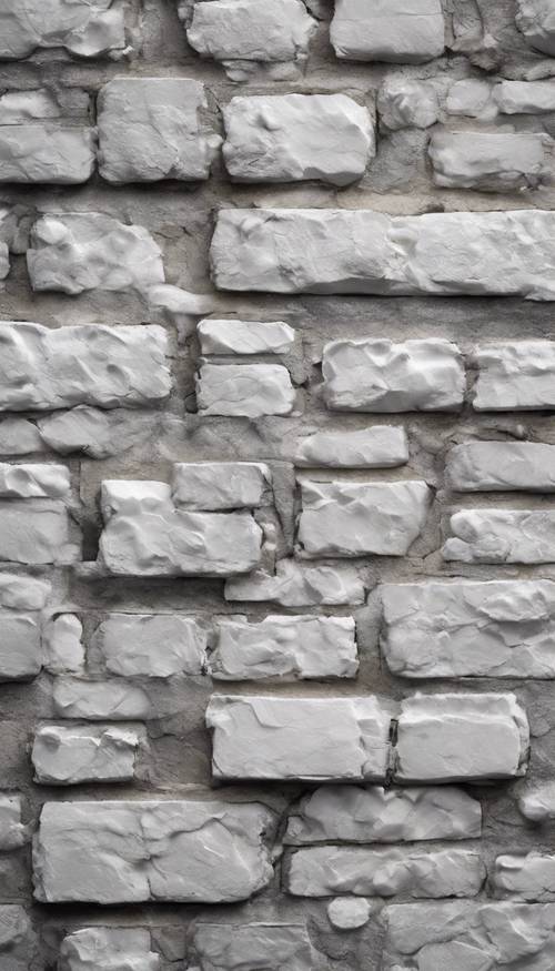Um close de uma parede de tijolos cinza e branco.