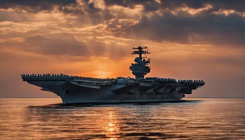 Gran portaaviones de la flota naval moderna con un impresionante atardecer como telón de fondo.