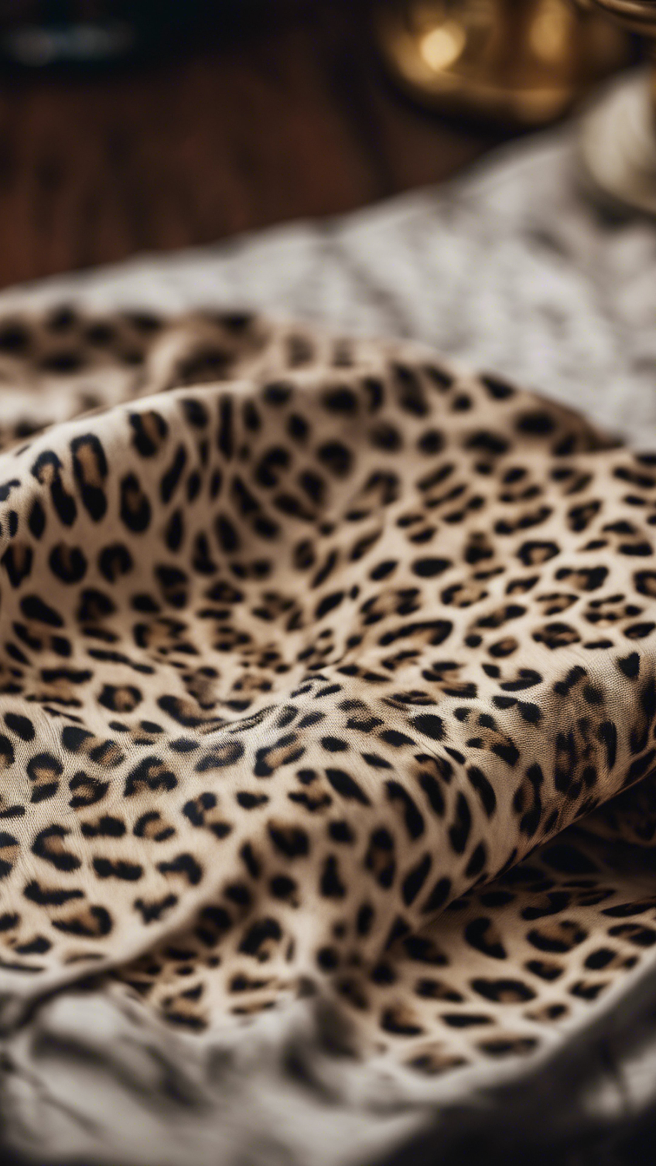 A fabric swatch draped over a table showcasing a unique cheetah print. Wallpaper[045b805c2a574901ba75]