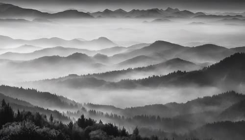 Paysage de montagne brumeux en noir et blanc avec des sommets à peine visibles.