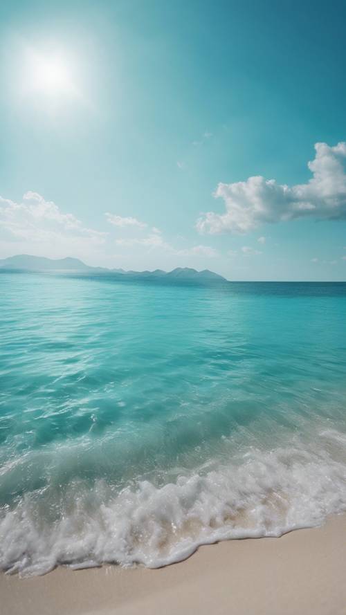 A clear, striking blue sky over a calm turquoise sea.