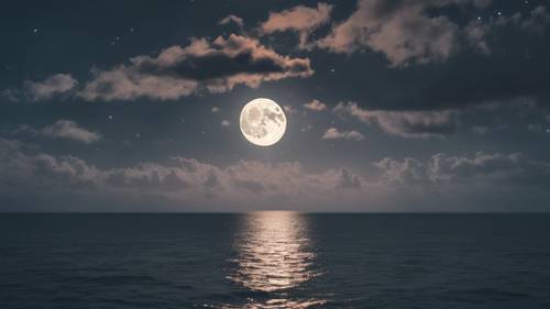 Bulan purnama diselimuti selubung tipis awan putih, memancarkan cahaya yang tidak wajar di atas laut tenang di bawahnya.